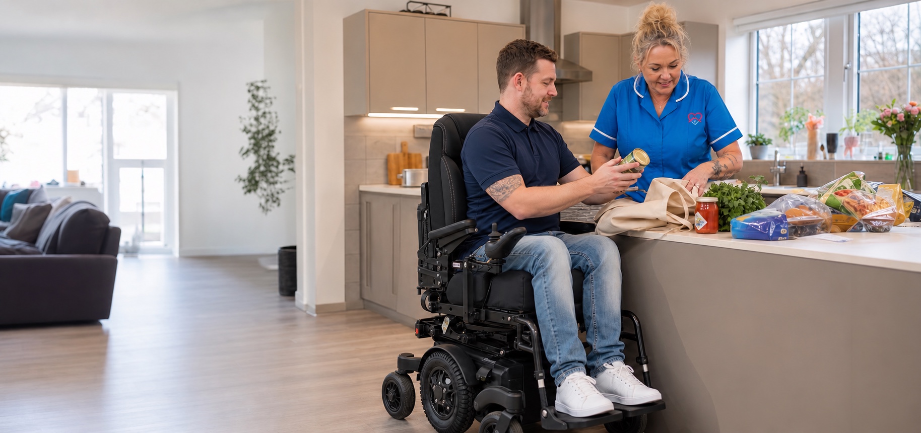 A man in a high-backed powerchair and a Help to Live carer organising groceries